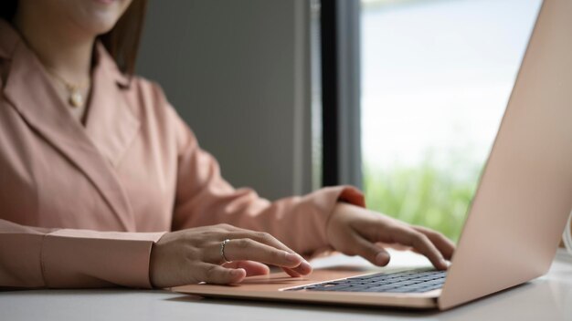 Cropped shot businesswoman working online with laptop computer