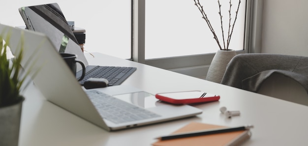 Cropped shot of comfortable workspace with laptop computer and office supplies 