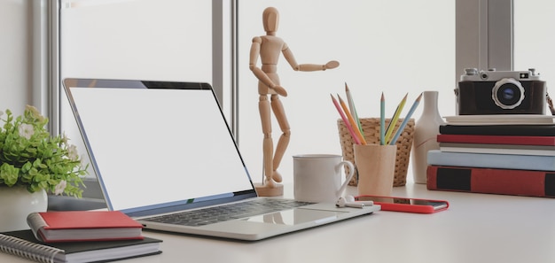 Cropped shot of comfortable workspace with laptop computer and office supplies 