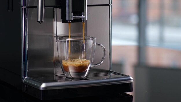 Cropped shot of cup in coffee maker