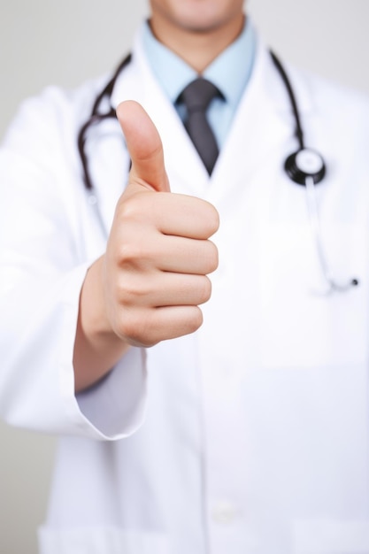 Cropped shot of a doctor showing thumbs up created with generative ai