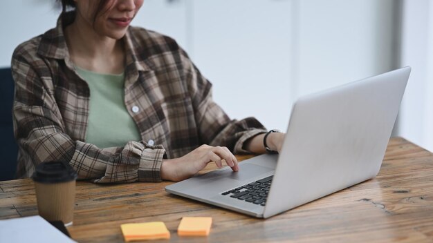 Cropped shot female designer using laptop computer