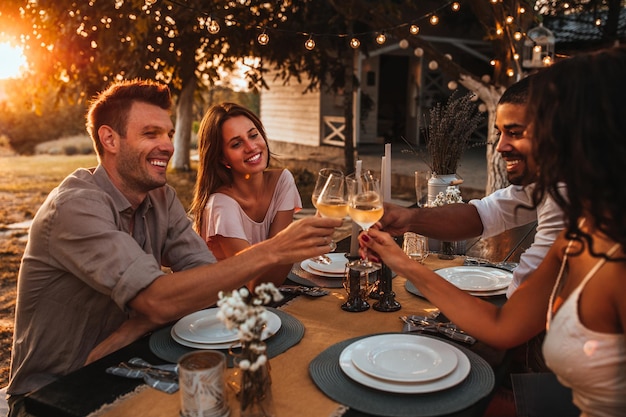 Cropped shot of a group of friends having a toast Warm tones