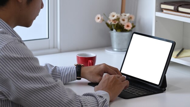 Cropped shot of male designer is working with computer tablet at his creative workspace.