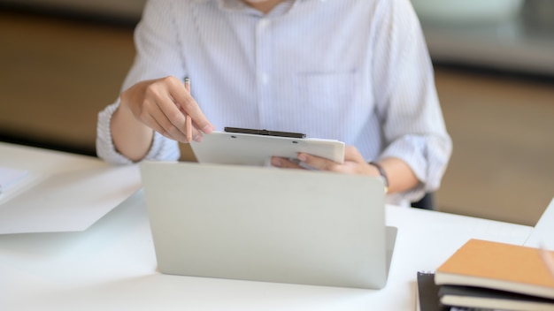 Обрезанный снимок мужского предпринимателя, анализ файла документа с ноутбуком и канцелярских принадлежностей