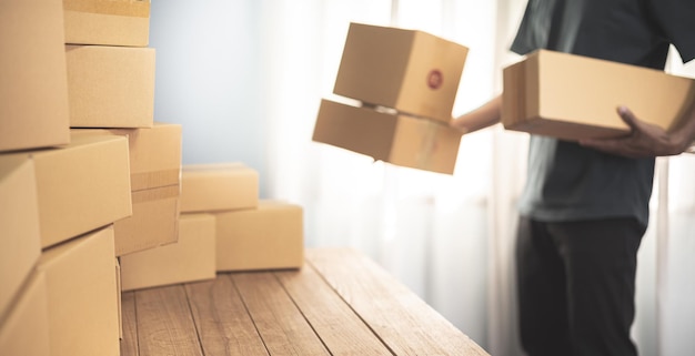 Photo cropped shot of man preparing a parcel for delivery at online selling business office.