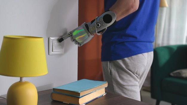 Cropped shot of man with prosthetic arm turn on and off lights in living room