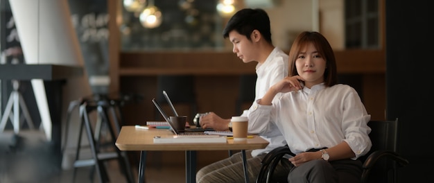 Cropped shot of smart businesswoman sitting at modern workplace