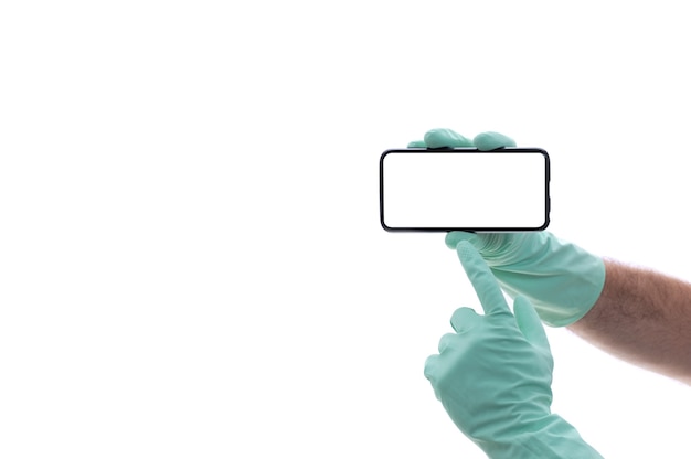 Cropped shot of an unrecognizable mans hand with green latex glove showing a black mobile phone screen with white blank for your text or logo