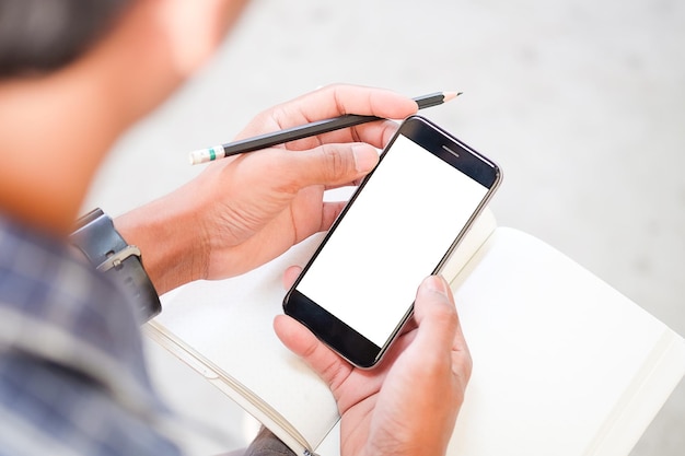 Cropped shot view of man hands holding smart phone with blank copy space screen for your text message or information content female reading text message on cell telephone during in urban setting