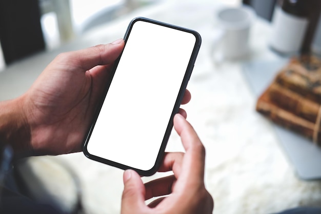 cropped shot view of man hands holding smart phone with blank copy space screen for your text message or information content