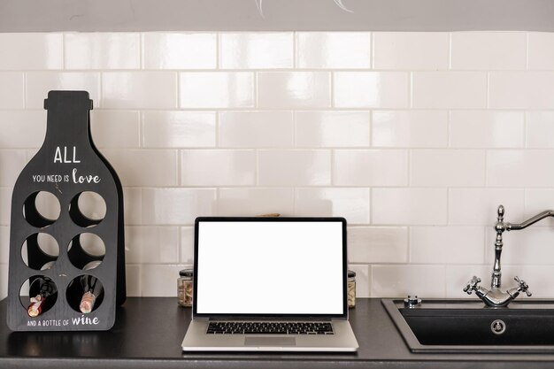 Cropped shot of workspace with laptop, stationery, cup in home office room.