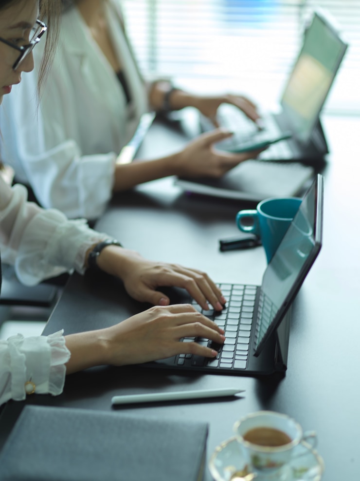 Photo cropped shot of young businesswomen team working on their project together in office room