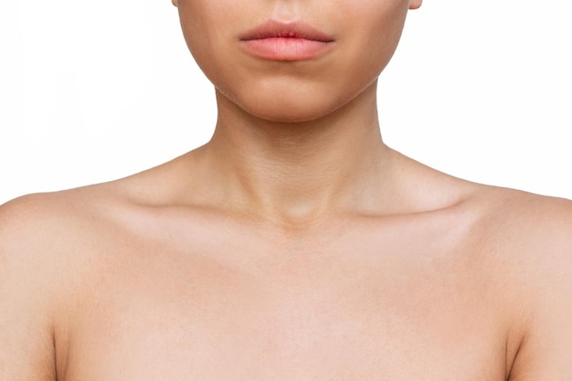 Cropped shot of a young woman with tender collarbone isolated on a white background