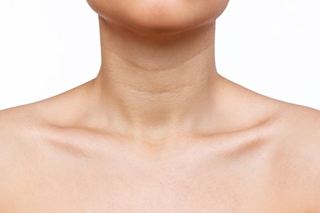 Cropped shot of young woman with wrinkles, age-related changes, rings of Venus, on her neck