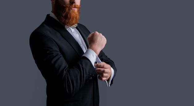 Cropped view of bearded gentleman in tuxedo isolated on grey background gentleman