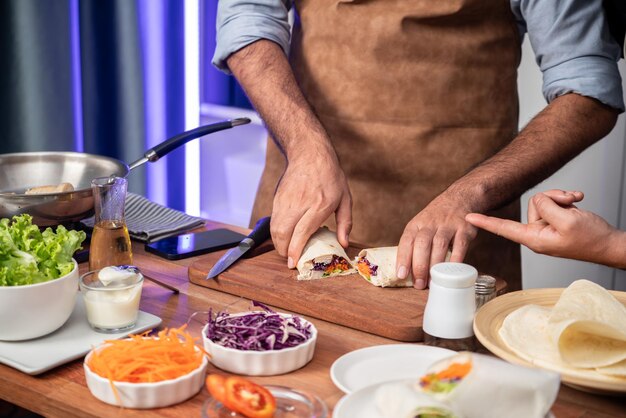 Photo cropped view of chef influencers presenting fresh salad roll sellable