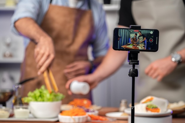 cropped view of chef influencers presenting fresh salad roll sellable