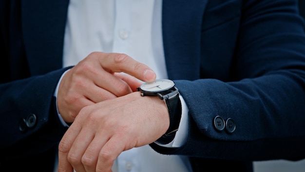 Cropped view closeup male hand with wristwatch clock asian middleaged businessman manager man male