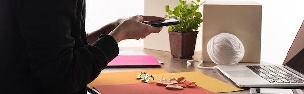 Cropped view of commercial photographer taking pictures of composition with accessories on