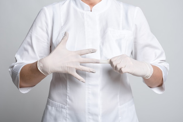 Cropped view of doctor in white latex gloves for protective virus. Protect yourself