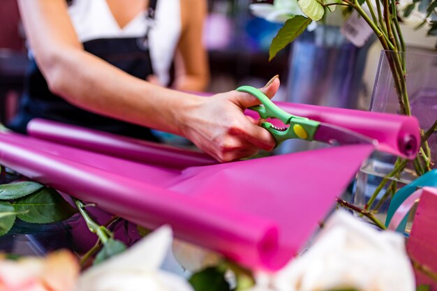 Cropped view of florist making flower bouquet close up