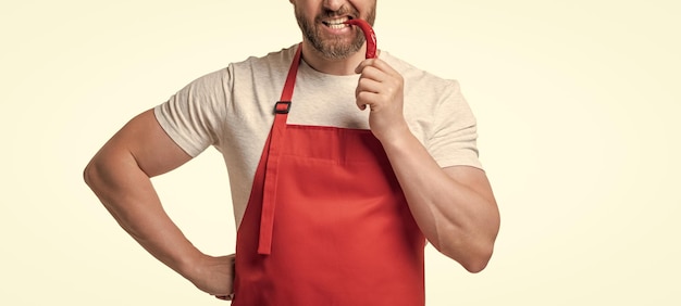 Photo cropped view of man in apron with chili vegetable isolated on white