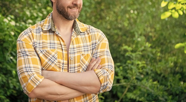 cropped view of man in checkered shirt caucasian man with beard mature man outdoor