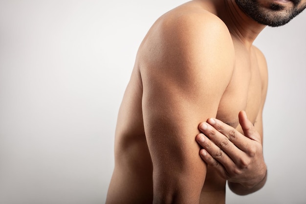 Cropped view of a man showing triceps, body pain concept