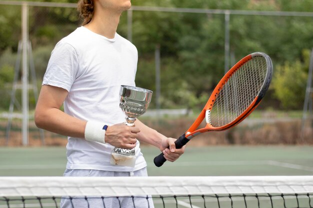 Cropped view of unrecogniable young man holding his award as 1st position on the championship competition