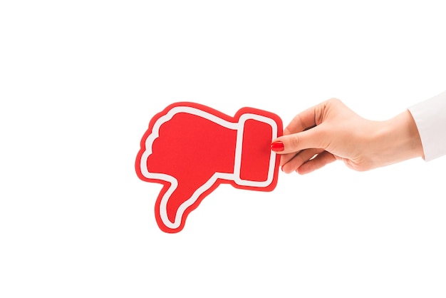 Cropped view of woman holding thumb down red sign isolated on white