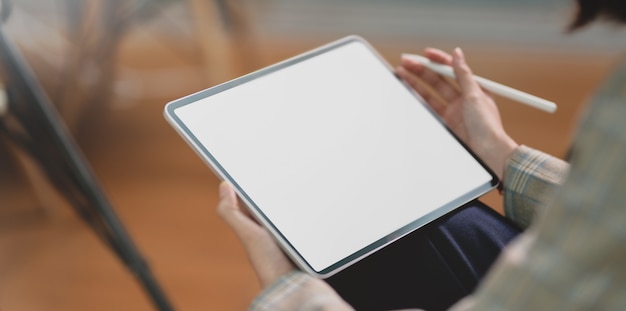 Cropped view of young businesswoman holding tablet 