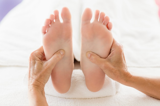 Cropped woman receiving foot massage