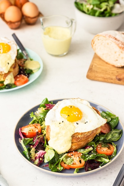 Croque Madame with ham, melted emmental, fried egg and bechamel.