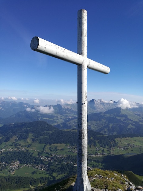 Cross against mountains