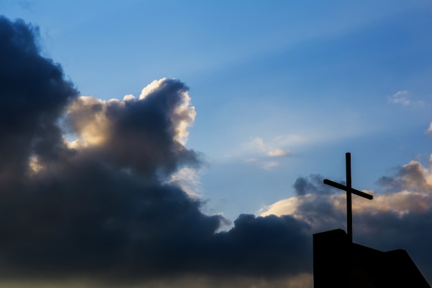 Cross against the sky background. Religious concept