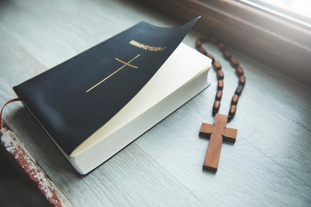 a cross and a bible on a table