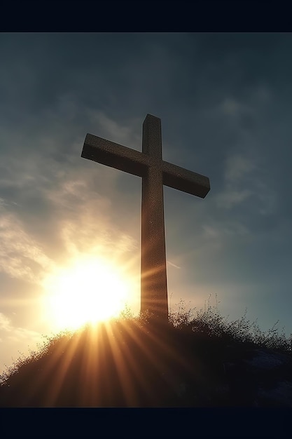 A cross on a hill with the sun shining behind it