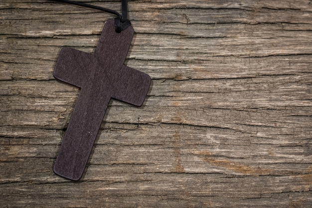 Cross pendant on the wooden table with copy space