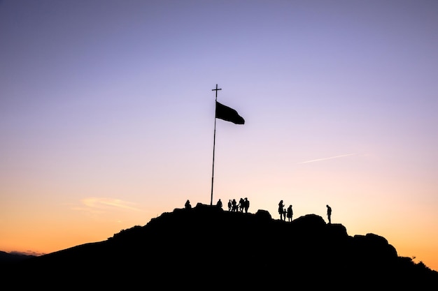 Cross and people at the sunset