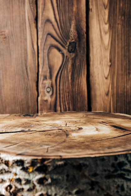 Cross-section of a tree on the background of wooden boards 