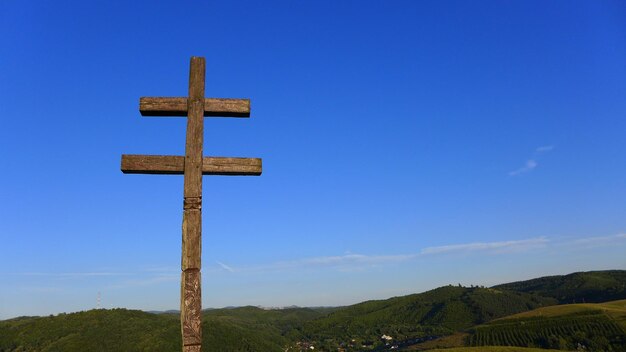 Cross sign against blue sky