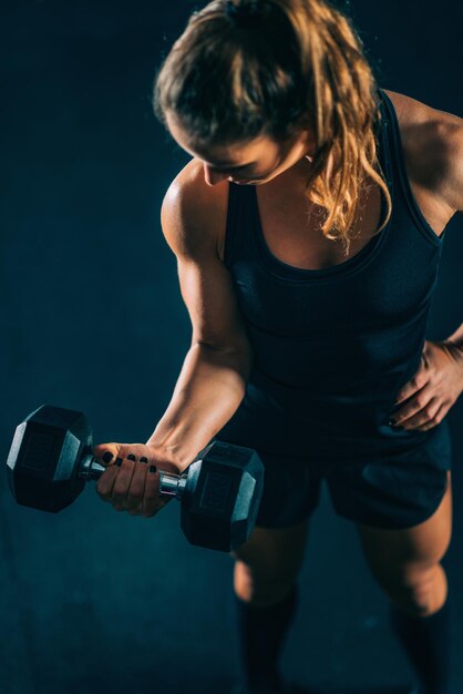 Cross training Young woman exercising at the gym