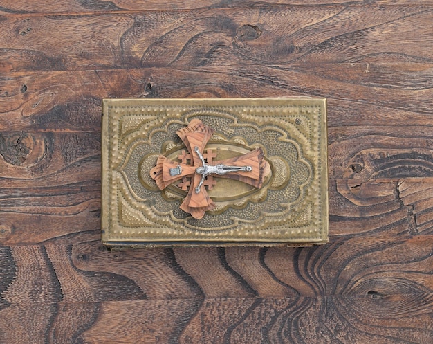 A cross on a wooden table with a cross on it.