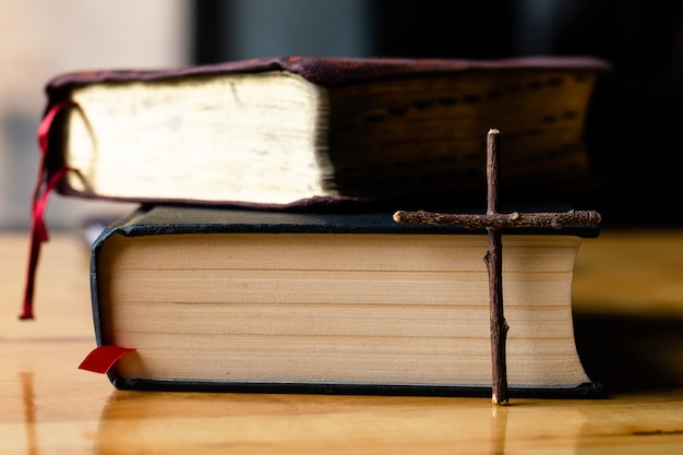 Crosses and bible on a wooden table