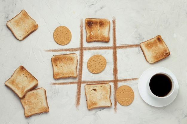 Foto crosses choice game competition cookie e square toast toast, tazza con caffè nero, pietra bianca