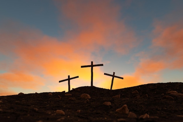 Crosses on mountain slope under sundown sky