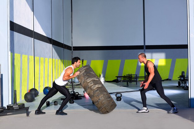 Crossfit flip tires men flipping each other