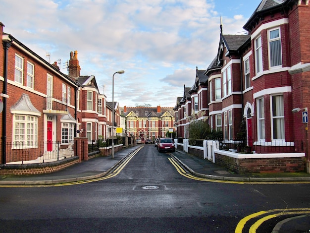 Photo crossing road and old red brick buildings