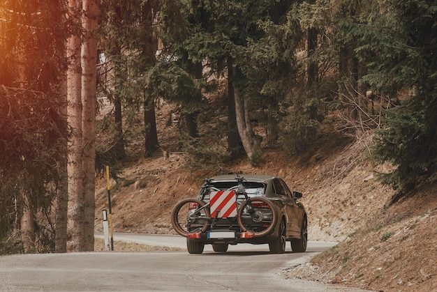 Crossover SUV car with two mountain bicycles loaded on a rack